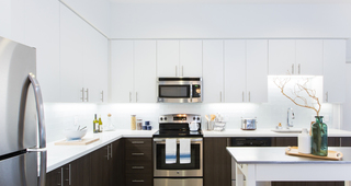 Modern kitchens with designer quartz countertops, stainless steel appliances and European-style wood cabinetry  